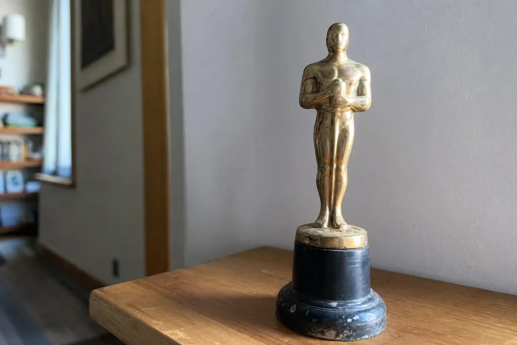 En sliten gyllene statyett i miniatyr fotograferad i naturligt dagsljus hemma, kopplad till På TV ikväll 1998 kom världens...